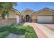 Inviting single-story home featuring a three-car garage, stone accents, and well-maintained landscaping at 11253 Sanbury Brook St, Las Vegas, NV 89183