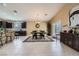 Open kitchen and dining area with dark cabinetry, granite countertops, and a spacious layout at 11253 Sanbury Brook St, Las Vegas, NV 89183