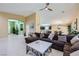 Bright and open living area with tile flooring and neutral decor, flowing into other living spaces at 11253 Sanbury Brook St, Las Vegas, NV 89183