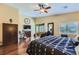 Another view of the main bedroom features a ceiling fan, hardwood floors, and a sitting area at 11253 Sanbury Brook St, Las Vegas, NV 89183