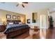 Cozy main bedroom with a fireplace, wood floors, and neutral tones; a relaxing retreat at 11253 Sanbury Brook St, Las Vegas, NV 89183