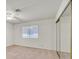 Well-lit bedroom with a ceiling fan and a window, complemented by a closet with sliding mirror doors at 1313 Pinto Rock Ln # 202, Las Vegas, NV 89128