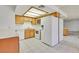 Kitchen with white appliances, bright lighting, and ample cabinet space at 1313 Pinto Rock Ln # 202, Las Vegas, NV 89128