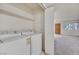 Laundry room with a washer and dryer, shelving, and access to the front door area at 1313 Pinto Rock Ln # 202, Las Vegas, NV 89128
