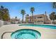 Community pool with jacuzzi and palm trees surrounding the area at 1313 Pinto Rock Ln # 202, Las Vegas, NV 89128