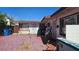 Red-tiled backyard featuring trash cans, a variety of items, and an entrance to the building at 1414 Rexford Pl, Las Vegas, NV 89104