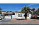 Cozy single-story home featuring desert landscaping, white exterior, and a small, gated front yard at 1414 Rexford Pl, Las Vegas, NV 89104