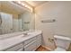 Clean bathroom with a white vanity, a large mirror, and a tiled floor, creating a functional and simple design at 1437 Daybreak Dr, Las Vegas, NV 89108