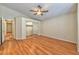 This bedroom features wood laminate floors, a mirrored closet, and neutral walls at 1437 Daybreak Dr, Las Vegas, NV 89108