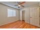 This bedroom features wood laminate floors, a closet with doors, and a ceiling fan at 1437 Daybreak Dr, Las Vegas, NV 89108