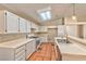 Bright kitchen featuring tile floors, white cabinets, a skylight, and modern appliances, providing a clean and airy atmosphere at 1437 Daybreak Dr, Las Vegas, NV 89108