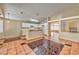 Bright kitchen with white cabinets, a breakfast bar, tile floor, and an adjacent living space, perfect for entertaining at 1437 Daybreak Dr, Las Vegas, NV 89108