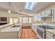 Well-lit kitchen with white countertops, tile flooring, and stainless-steel appliances, creating a modern and functional space at 1437 Daybreak Dr, Las Vegas, NV 89108