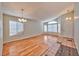 Bright living room featuring wood floors, large windows, and a classic chandelier, providing ample natural light at 1437 Daybreak Dr, Las Vegas, NV 89108