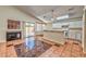 Open-concept living space with a cozy fireplace, tiled flooring, and bright kitchen with a breakfast bar at 1437 Daybreak Dr, Las Vegas, NV 89108