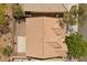 Aerial view of a home with a tile roof, green trees, and a small patio, showcasing its backyard and surrounding landscape at 1524 Remembrance Hill St, Las Vegas, NV 89144