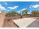 Backyard view showing the patio with a low brick wall and desert landscaping at 1524 Remembrance Hill St, Las Vegas, NV 89144