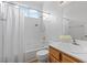 Bright bathroom featuring white tile surround, a shower over tub and white shower curtain at 1524 Remembrance Hill St, Las Vegas, NV 89144