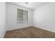 This bedroom features neutral carpet, window with blinds, and white walls for a clean and serene space at 1524 Remembrance Hill St, Las Vegas, NV 89144