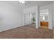 Carpeted bedroom with walk-in closet, ceiling fan, and an ensuite bathroom featuring vanity and lighting at 1524 Remembrance Hill St, Las Vegas, NV 89144