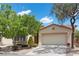 Charming single-story home with a well-maintained lawn and mature trees, featuring a two-car garage and neutral tones at 1524 Remembrance Hill St, Las Vegas, NV 89144
