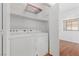 Convenient laundry room featuring a washer, dryer and storage shelves at 1524 Remembrance Hill St, Las Vegas, NV 89144