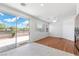 Bright living room with wood floors, sliding glass doors to patio, ceiling fan, and neutral paint at 1524 Remembrance Hill St, Las Vegas, NV 89144