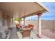 Back patio featuring comfortable seating, a grill, and decorative pillars at 1552 Livingston Dr, Henderson, NV 89012
