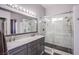 This modern bathroom offers a double vanity sink with a large frameless shower, offering ample space at 1552 Livingston Dr, Henderson, NV 89012