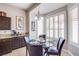 Cozy breakfast nook featuring a glass-top table, leather chairs, and bright window shutters at 1552 Livingston Dr, Henderson, NV 89012