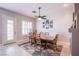 Elegant dining room featuring wood furniture, modern decor, and a stylish ceiling fan at 1552 Livingston Dr, Henderson, NV 89012