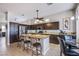 Gourmet kitchen features an island with seating, stainless steel appliances, and granite countertops at 1552 Livingston Dr, Henderson, NV 89012