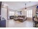 Inviting living room featuring a large sectional sofa, plantation shutters, and a bar area at 1552 Livingston Dr, Henderson, NV 89012