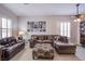 Comfortable living area featuring tile floors, a sectional sofa, plantation shutters, and a curated gallery wall at 1552 Livingston Dr, Henderson, NV 89012