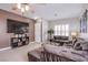 Spacious living room with a large sectional sofa, plantation shutters, and a mounted television at 1552 Livingston Dr, Henderson, NV 89012