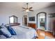 Spacious main bedroom featuring hardwood floors, neutral walls, and a ceiling fan at 1552 Livingston Dr, Henderson, NV 89012