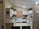 Functional kitchen with white appliances, tile countertops, and ample cabinet space at 1821 Windy Gap St, Las Vegas, NV 89106