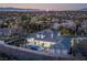 Beautiful estate with a large backyard pool and patio area, surrounded by lush landscaping and mature trees at 1865 Woodhaven Dr, Henderson, NV 89074