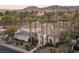 Stunning aerial view of the home, showcasing mature trees and landscaping, set against a mountain backdrop at 1865 Woodhaven Dr, Henderson, NV 89074
