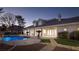 Gorgeous backyard featuring a custom pool, spacious patio, and lush landscaping perfect for entertaining at 1865 Woodhaven Dr, Henderson, NV 89074