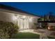 Charming backyard with a cozy outdoor fire pit, well-lit patio, and neatly landscaped garden at 1865 Woodhaven Dr, Henderson, NV 89074