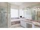 Spacious primary bathroom with marble finishes, dual sinks, soaking tub, and walk-in shower at 1865 Woodhaven Dr, Henderson, NV 89074