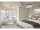 Bright bedroom featuring a sitting area near bay windows and modern chandelier lighting at 1865 Woodhaven Dr, Henderson, NV 89074
