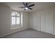 Neutral bedroom featuring a large window with shutters, window seat, and double closets at 1865 Woodhaven Dr, Henderson, NV 89074