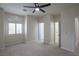 Bedroom featuring a ceiling fan, and an arched window with a window seat at 1865 Woodhaven Dr, Henderson, NV 89074