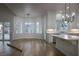 Bright dining area with a view of the kitchen, featuring lots of natural light from large windows at 1865 Woodhaven Dr, Henderson, NV 89074