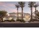 Expansive single-story home with lush landscaping, tile roof, and grand entrance framed by palm trees at 1865 Woodhaven Dr, Henderson, NV 89074