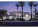 Expansive single-story home with lush landscaping, tile roof, and grand entrance framed by palm trees at 1865 Woodhaven Dr, Henderson, NV 89074
