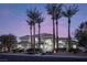 Expansive single-story home with lush landscaping, tile roof, and grand entrance framed by palm trees at 1865 Woodhaven Dr, Henderson, NV 89074
