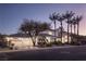 Sprawling home with a three car garage and mature landscaping, creating an inviting curb appeal at 1865 Woodhaven Dr, Henderson, NV 89074